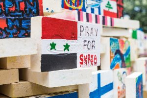 Hand painted tile stating "Pray for Syria".