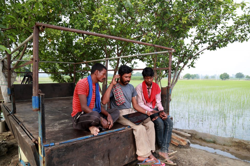Real people using laptop outdoor in the nature Global Development