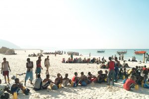 Refugees and migrants line up on a Somalia beach to board the boats that will take them across the Gulf of Aden to Yemen. In a military style operation, the passengers board the small smugglers’ boats in groups of 10. The overcrowded boats can take days to cross. Alixandra Fazzina