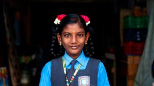 Indian girl in school uniform looking at camera