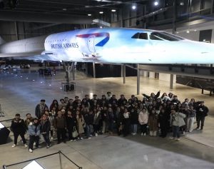 Group of students in front of a plane